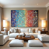 Modern living room with a colorful abstract painting on the wall, white sofa, and wooden coffee table.