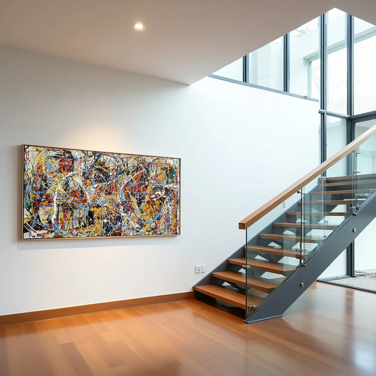 Modern interior with a colorful abstract painting on a wall above a staircase.
